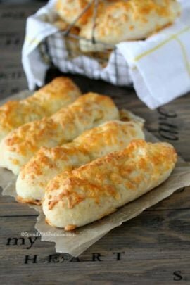 Cheesy Garlic Breadsticks on parchment paper