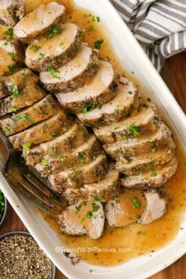 Pork tenderloin on a plate with gravy