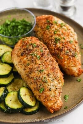 plated Air Fryer Split Lemon Pepper Chicken Breasts with cucumbers