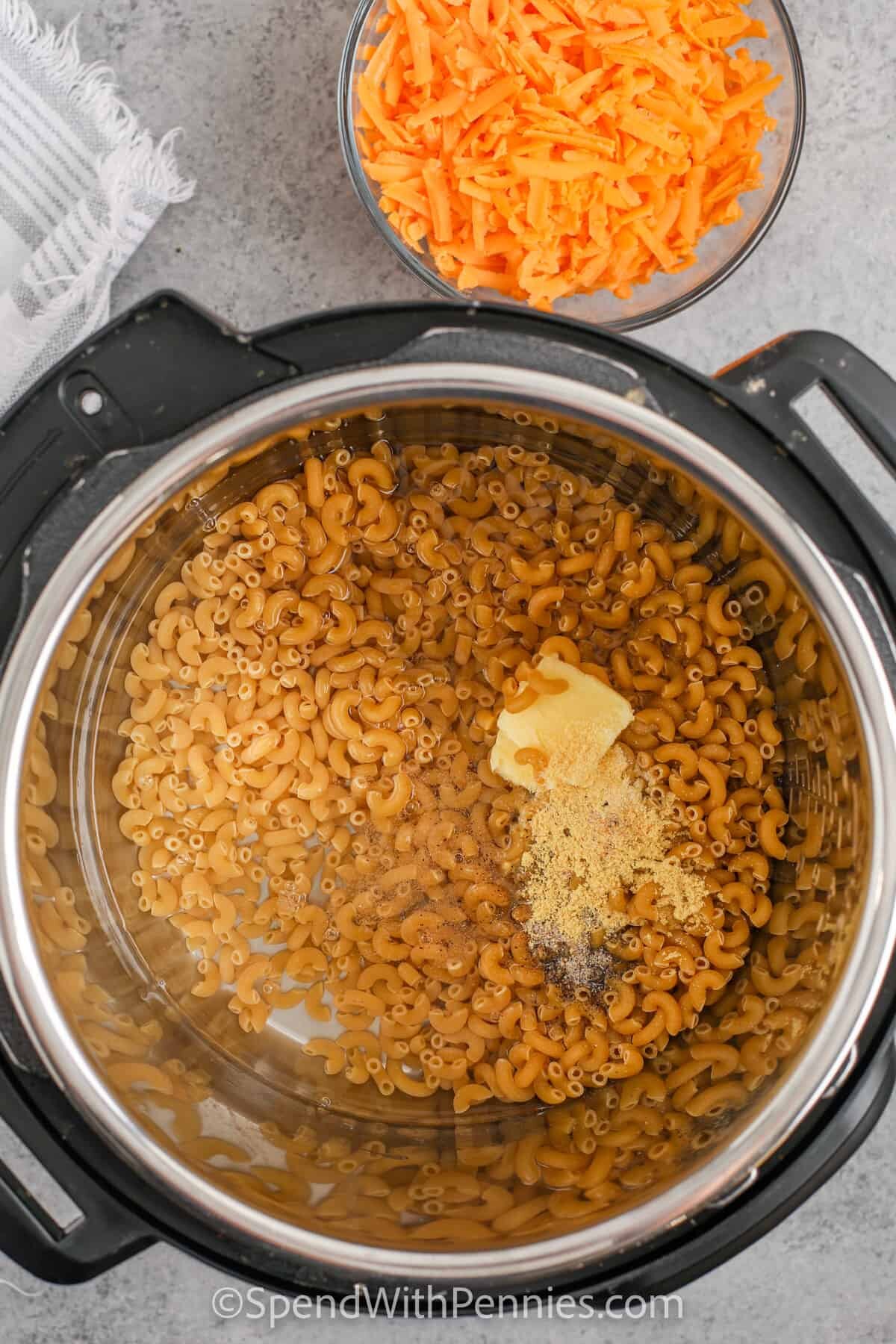 Mac and Cheese ingredients being added to the Instant Pot