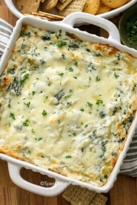 spinach artichoke dip in a white dish