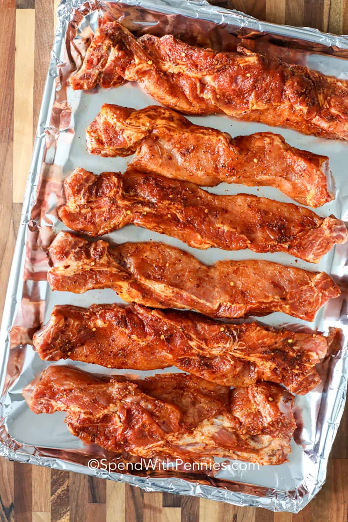 seasoned ribs on a sheet pan to make BBQ Country Style Ribs