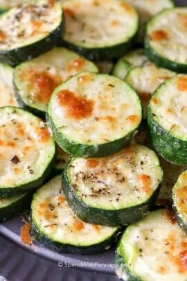 baked zucchini topped with cheese on a plate